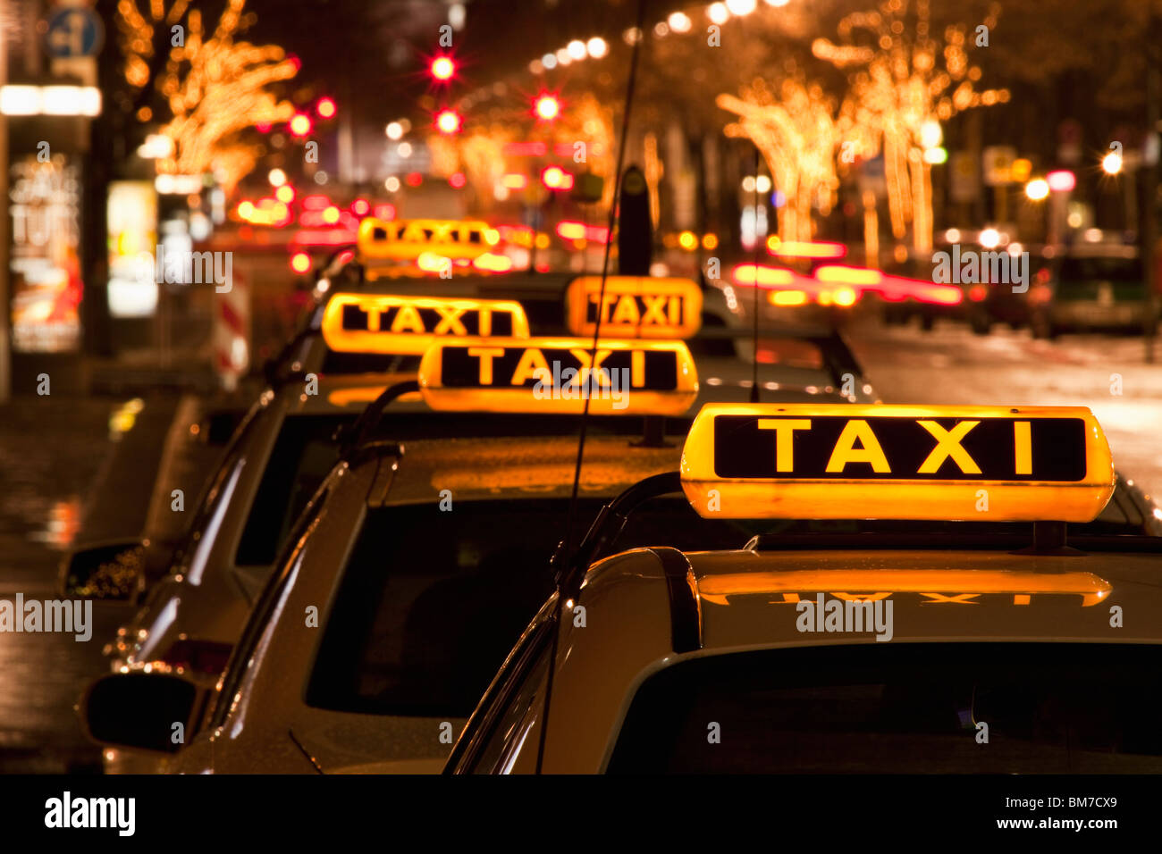 Detail of taxi cabs parked in a row at night Stock Photo