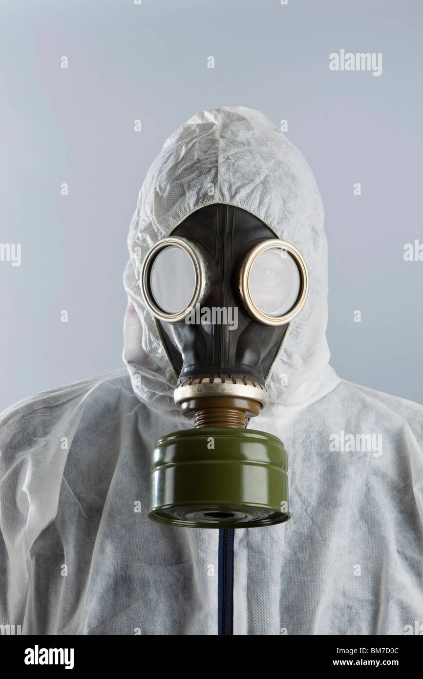 A man wearing a gas mask and protective suit Stock Photo