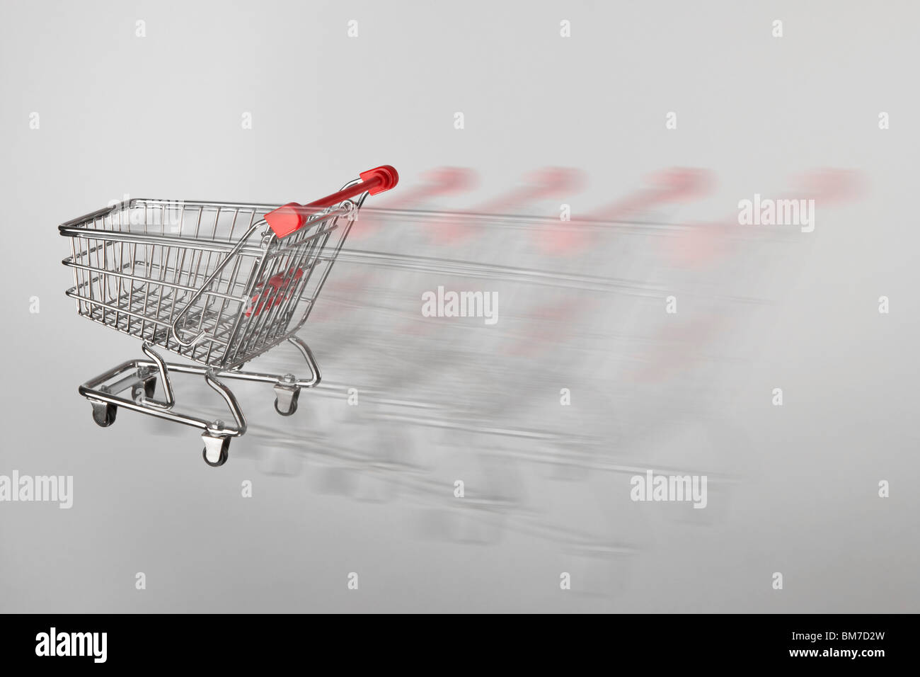 A miniature shopping cart on the move Stock Photo