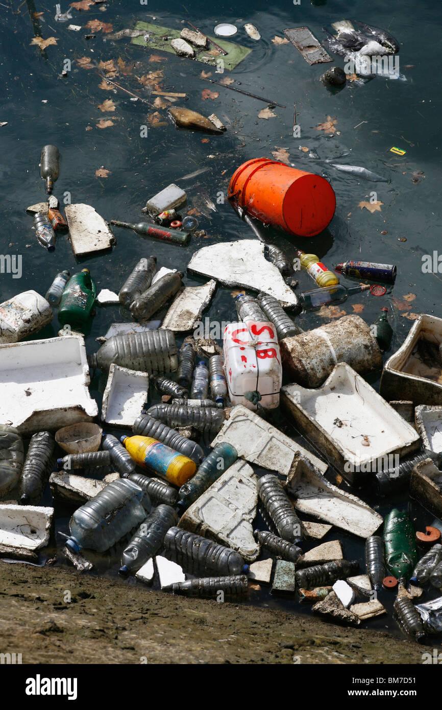 Litter floating in dirty water Stock Photo