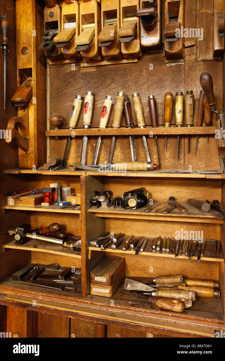 Antique woodworkers cabinet with various tools Stock Photo