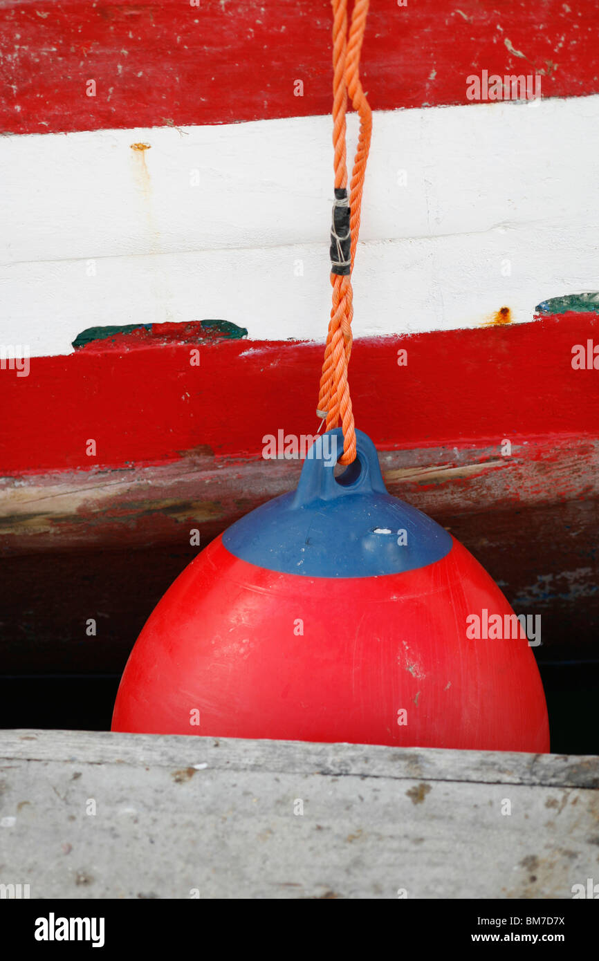 A boat bumper tied to a boat docked at a jetty Stock Photo Alamy
