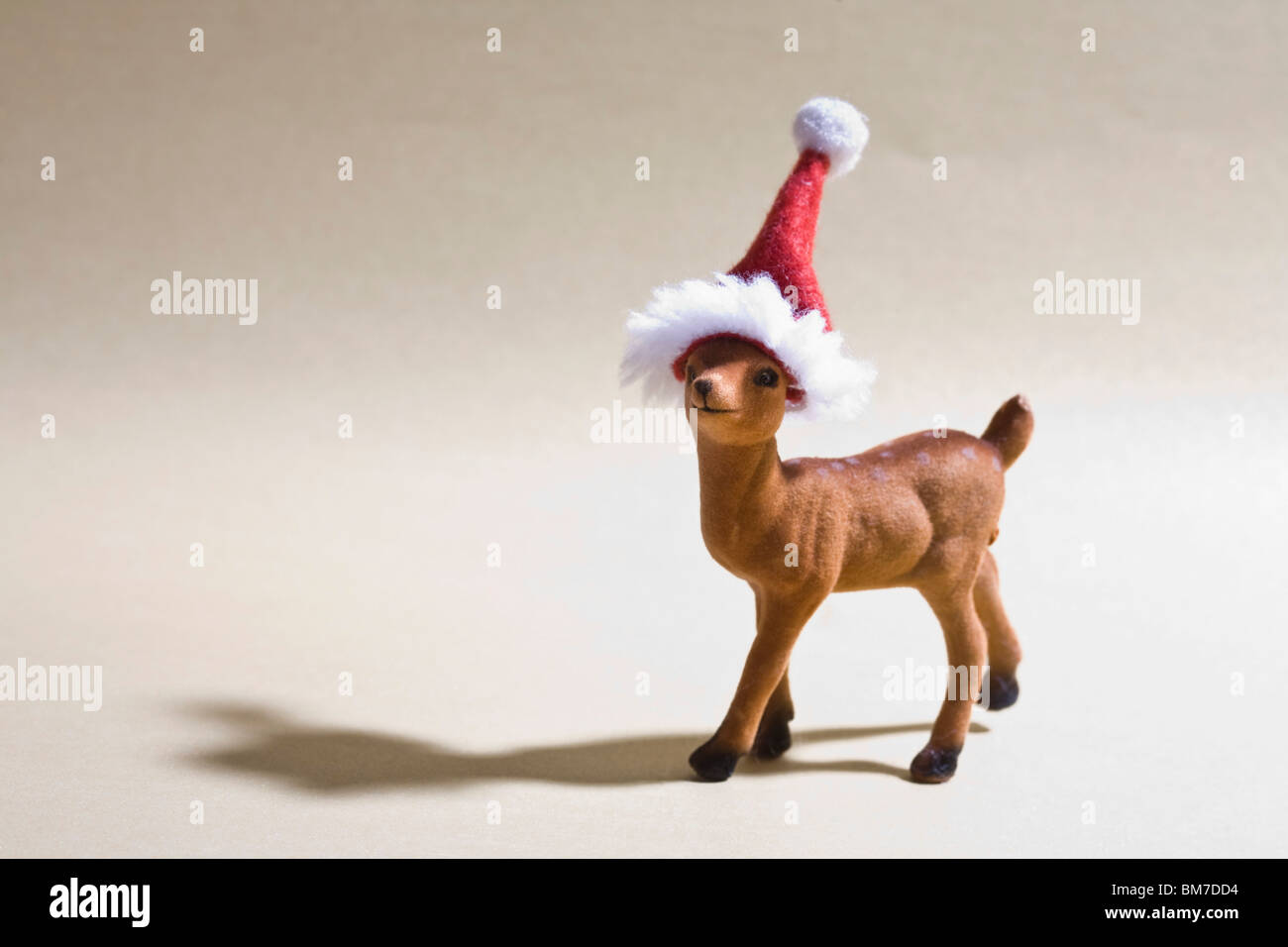 A reindeer figurine wearing a Santa hat Stock Photo - Alamy