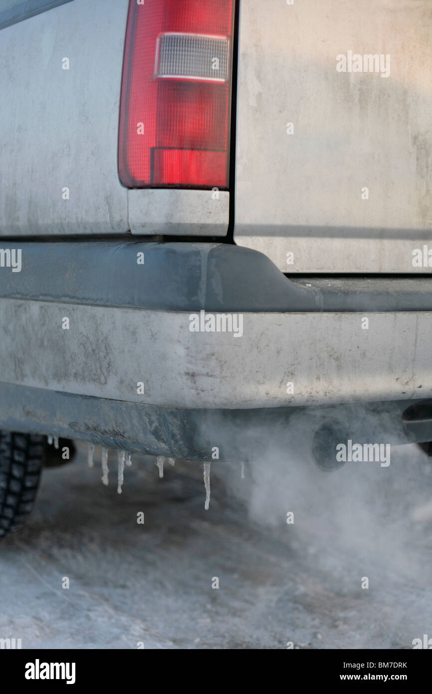 A car exhaust pipe emitting fumes Stock Photo