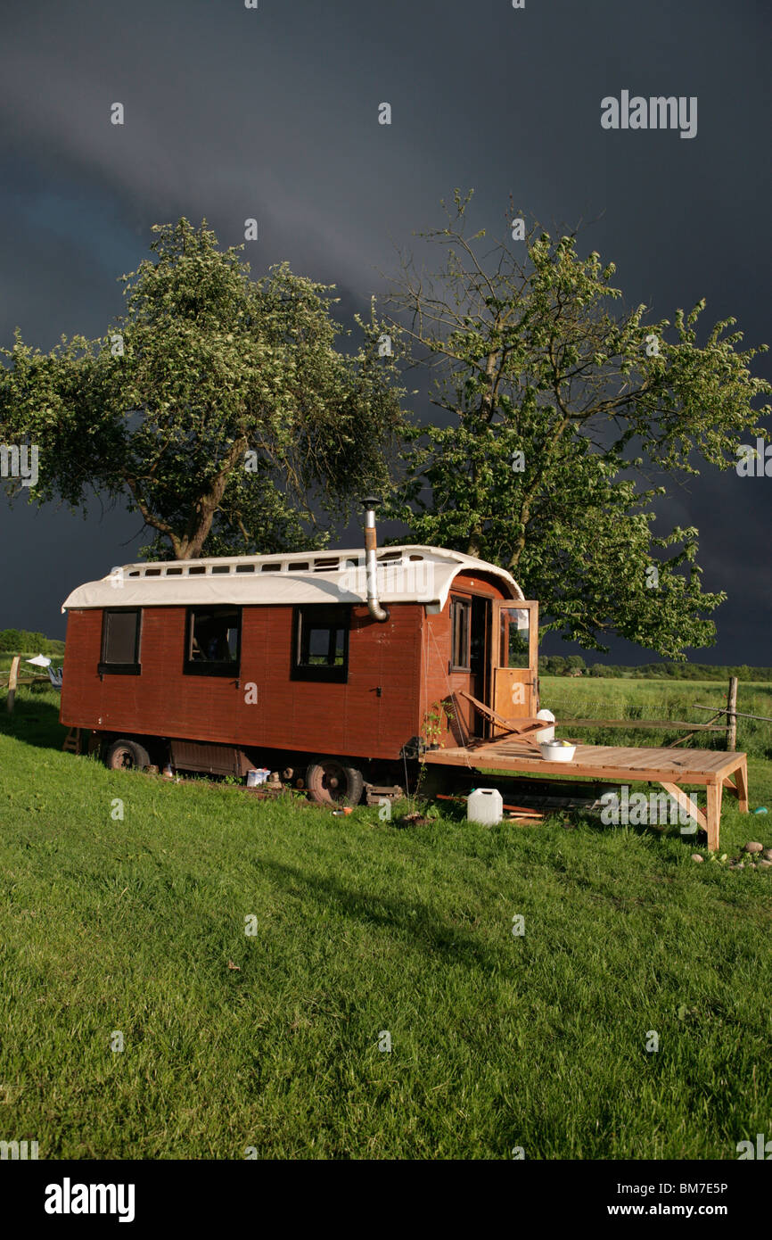 A wooden caravan parked in a rural area Stock Photo