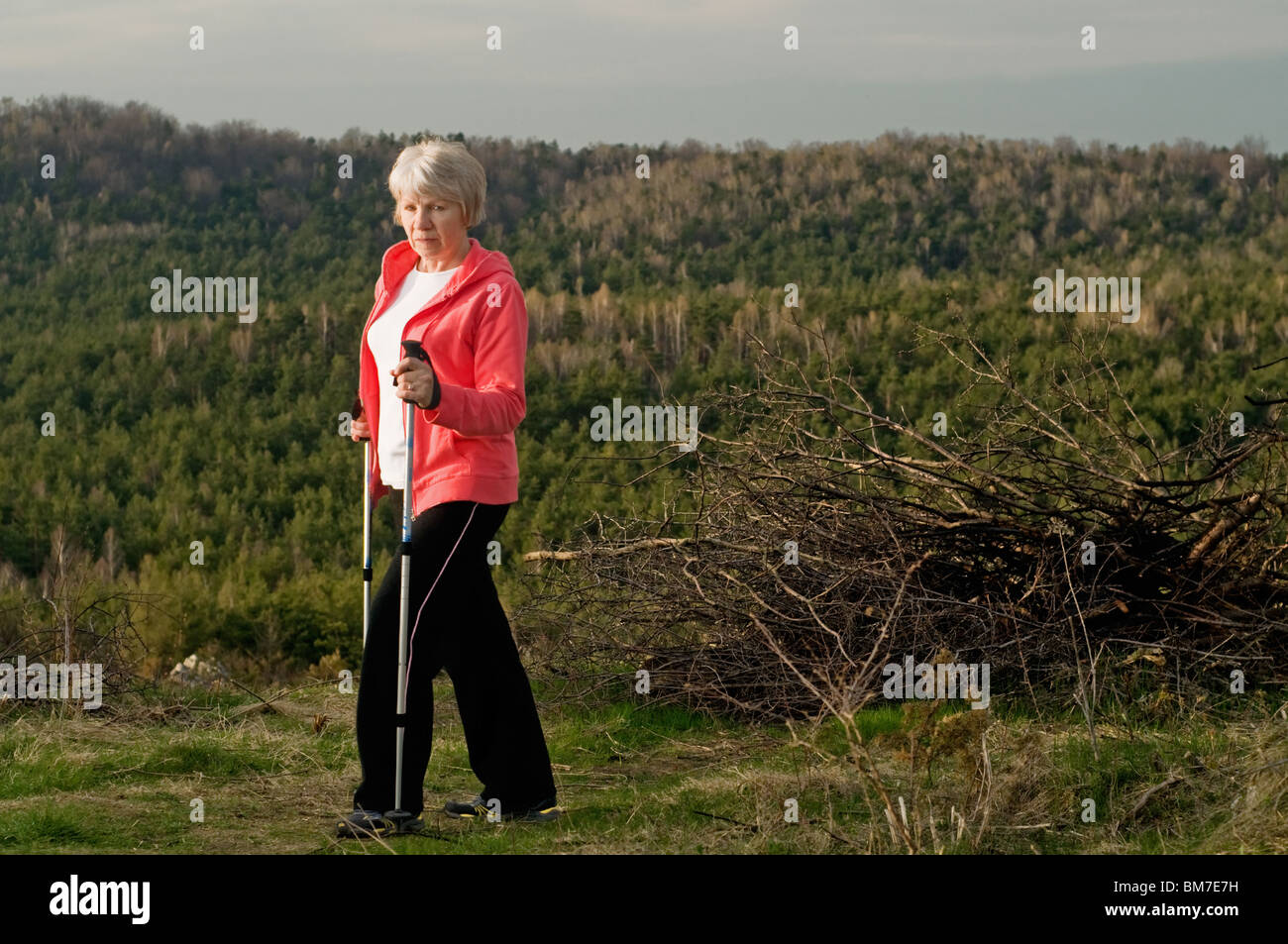 Senior woman walking in park hi-res stock photography and images - Alamy