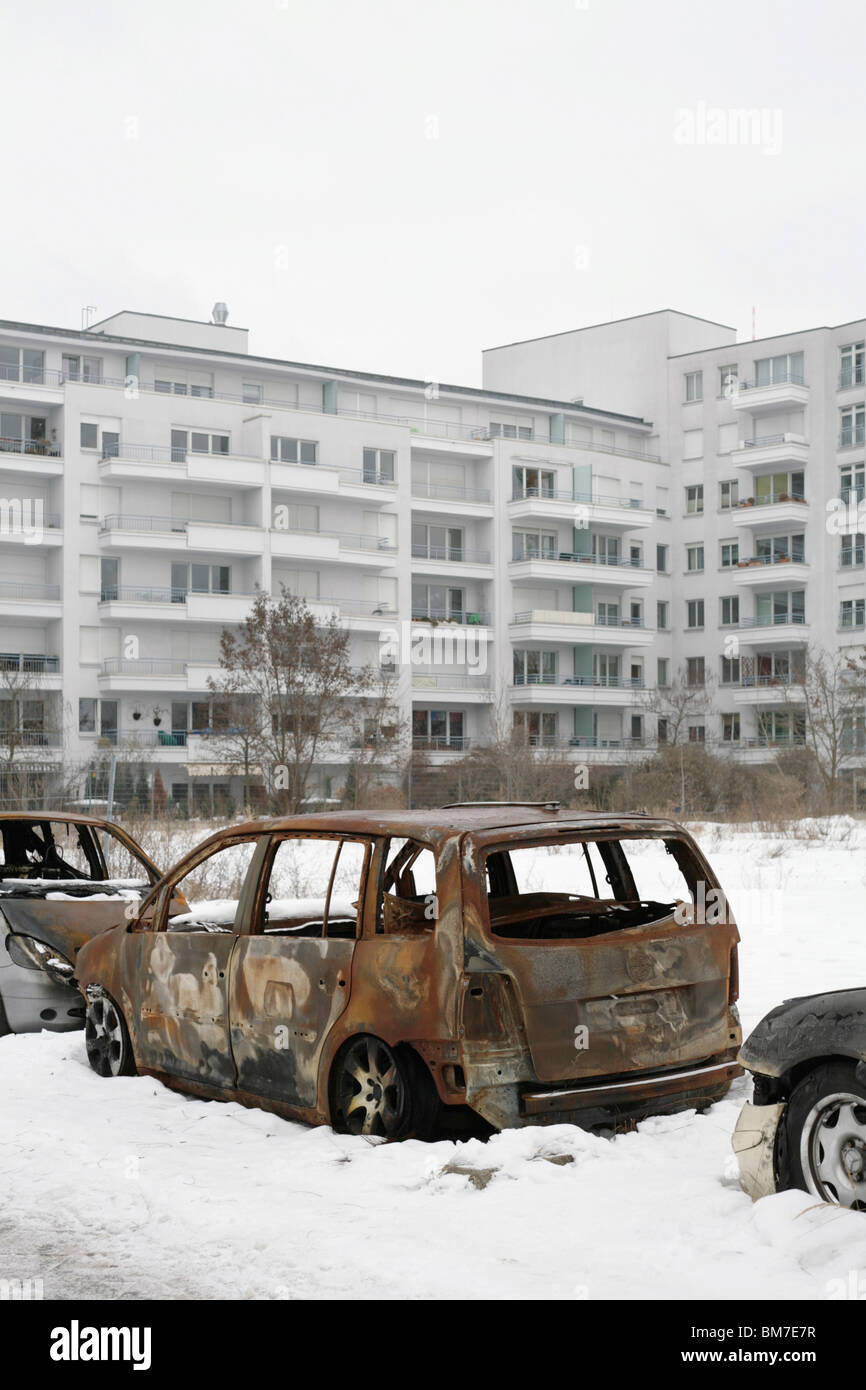 Burned out cars on a snow covered street Stock Photo