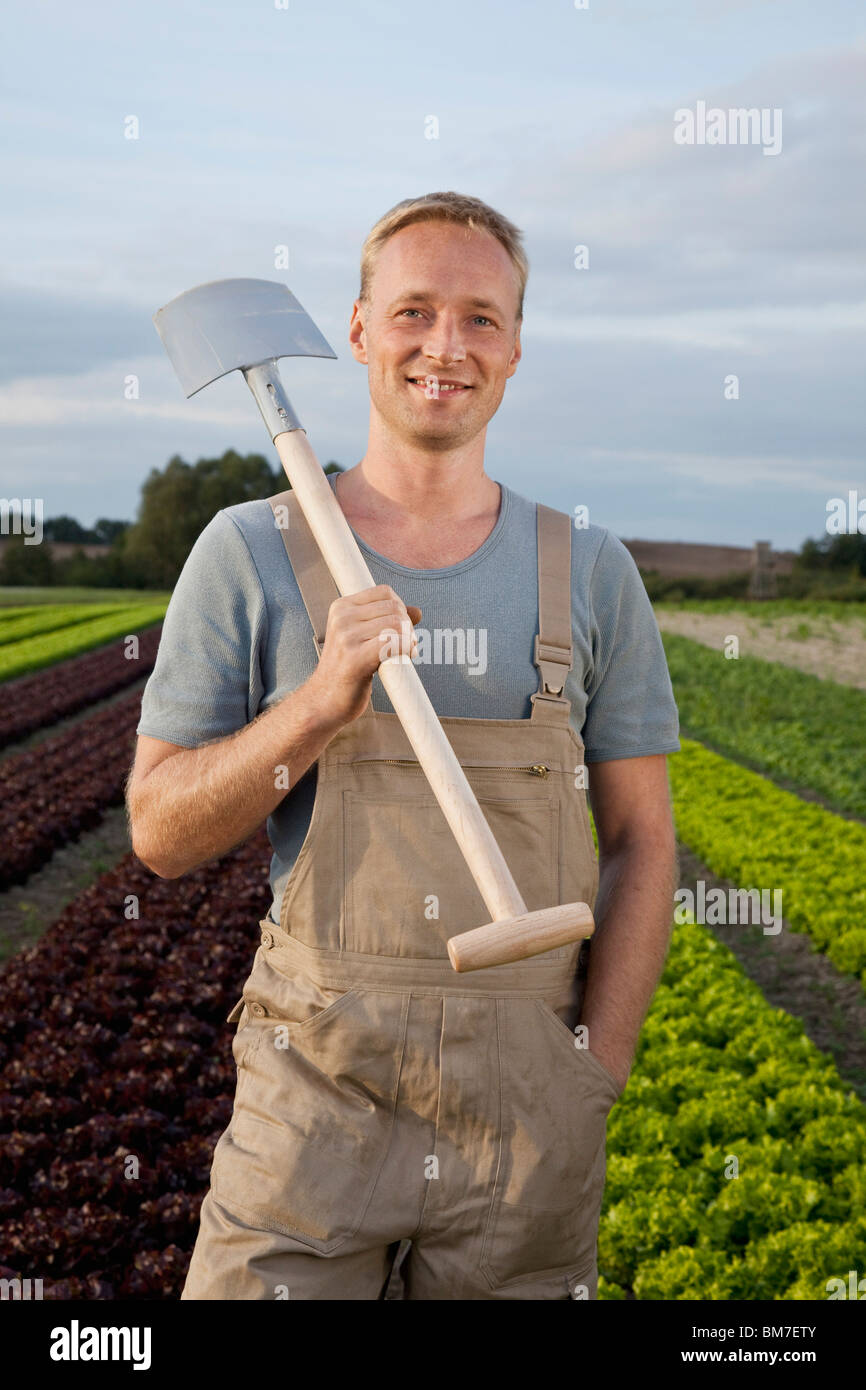 A man carrying a shovel on his shoulder Stock Photo Alamy