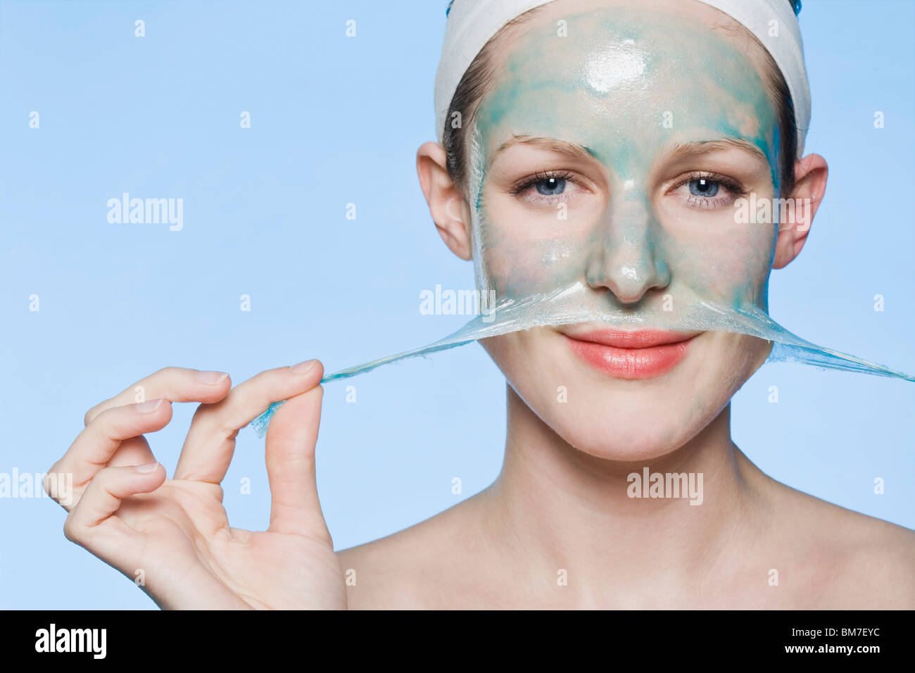 A woman peeling a face mask off her face Stock Photo Alamy
