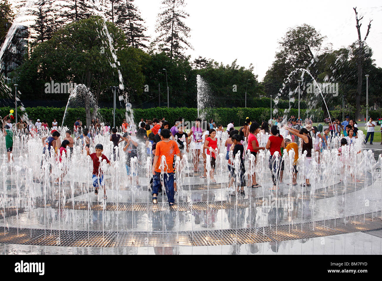 Children playing in one of the many fountains of  the Magic Water Tour ,Park of the Reserve,Lima,Mexico Stock Photo