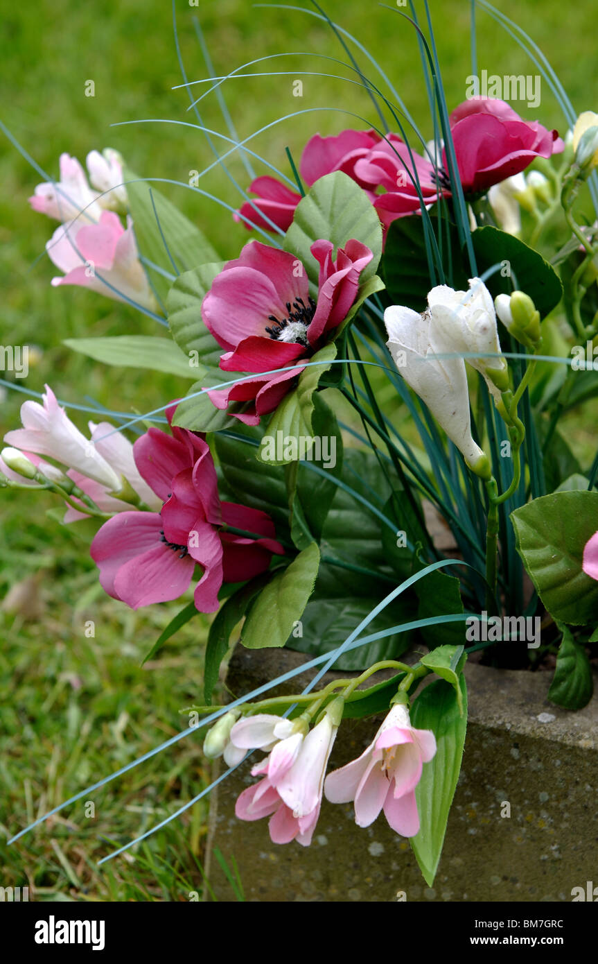 Artificial flowers on a grave Stock Photo Alamy