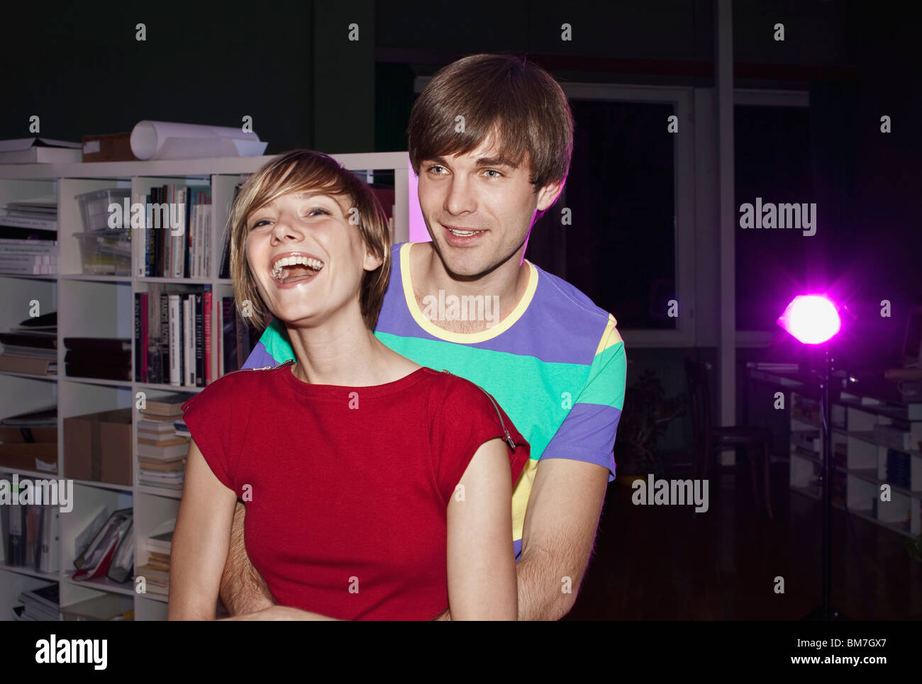 A young man with his arms around his girlfriend Stock Photo