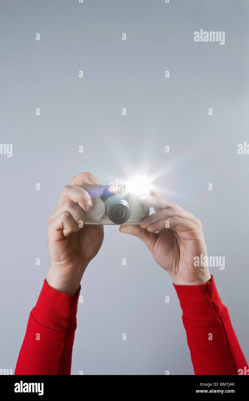 Detail of a man taking a photograph with a camera Stock Photo