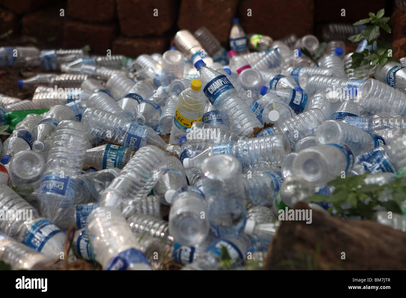 Waste plastic bottles piled up behind a beach in Goa, India. Stock Photo