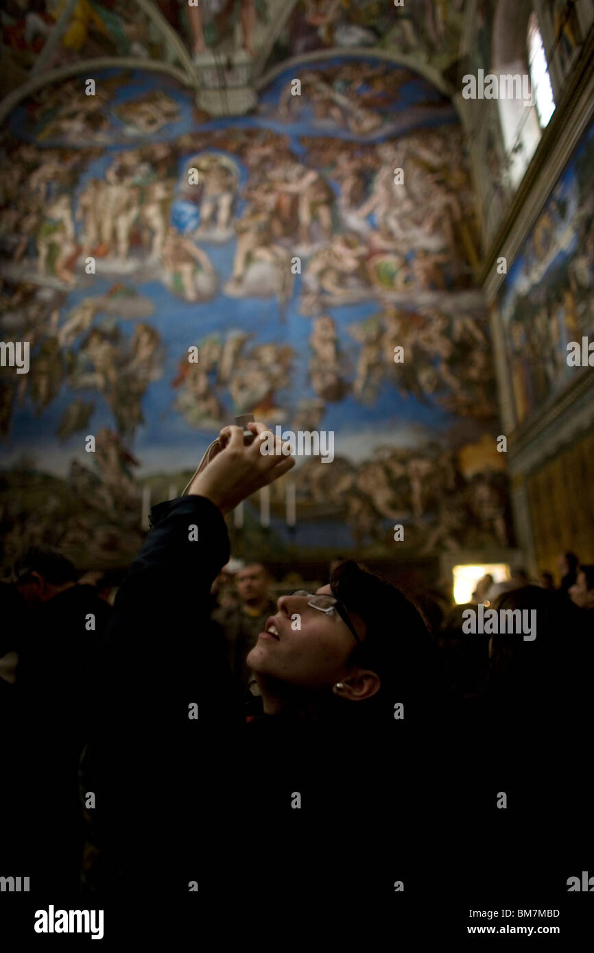 A Tourist Photographs The Ceiling Of The Sistine Chapel By