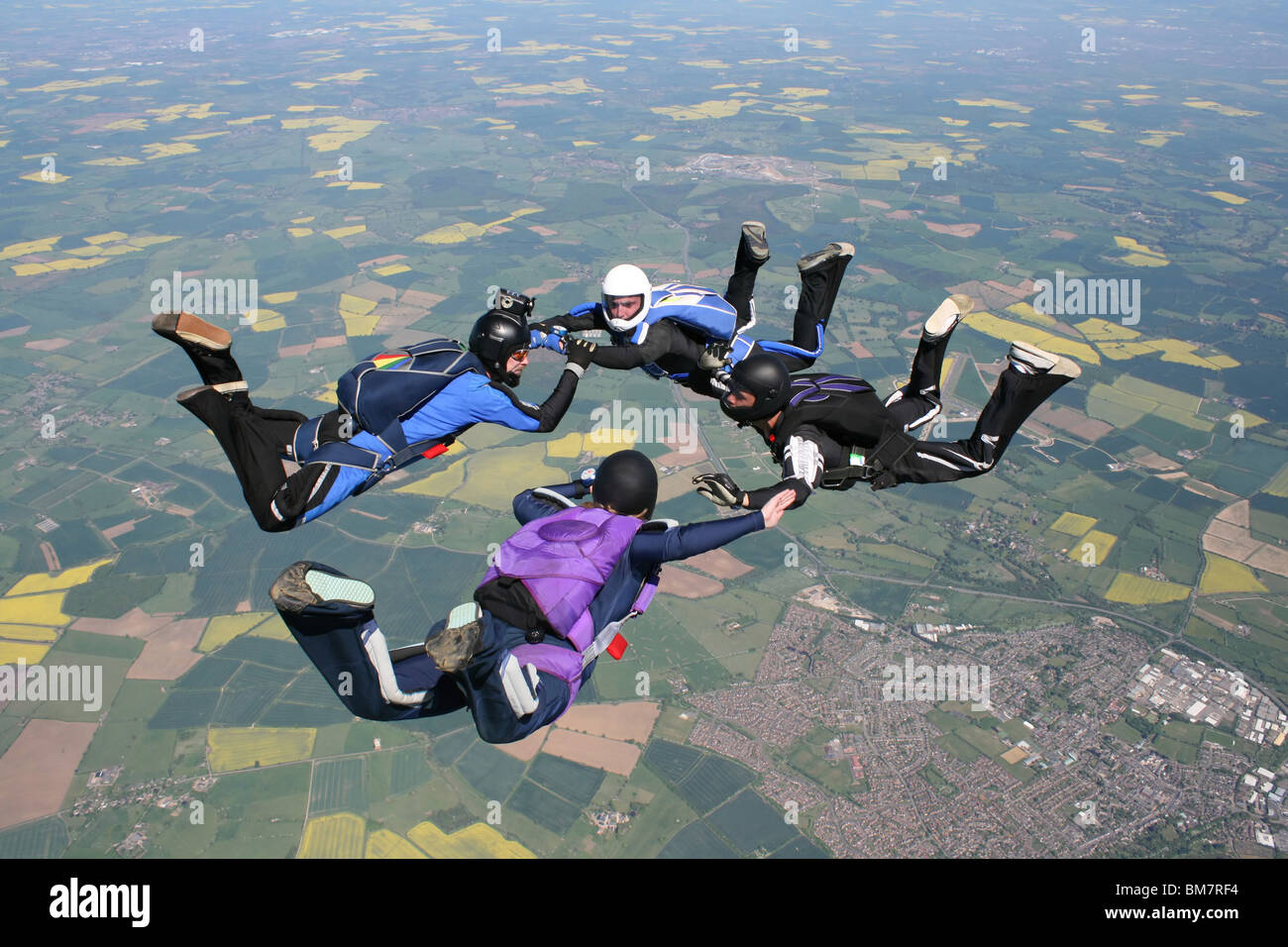 Four skydivers in free fall doing formations Stock Photo - Alamy