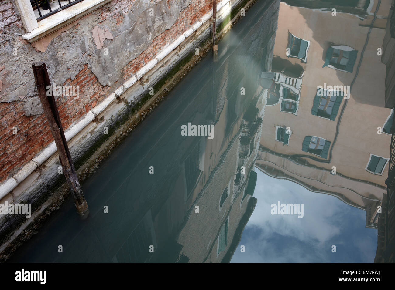 Reflection of architecture in a canal in Venice, Italy Stock Photo - Alamy