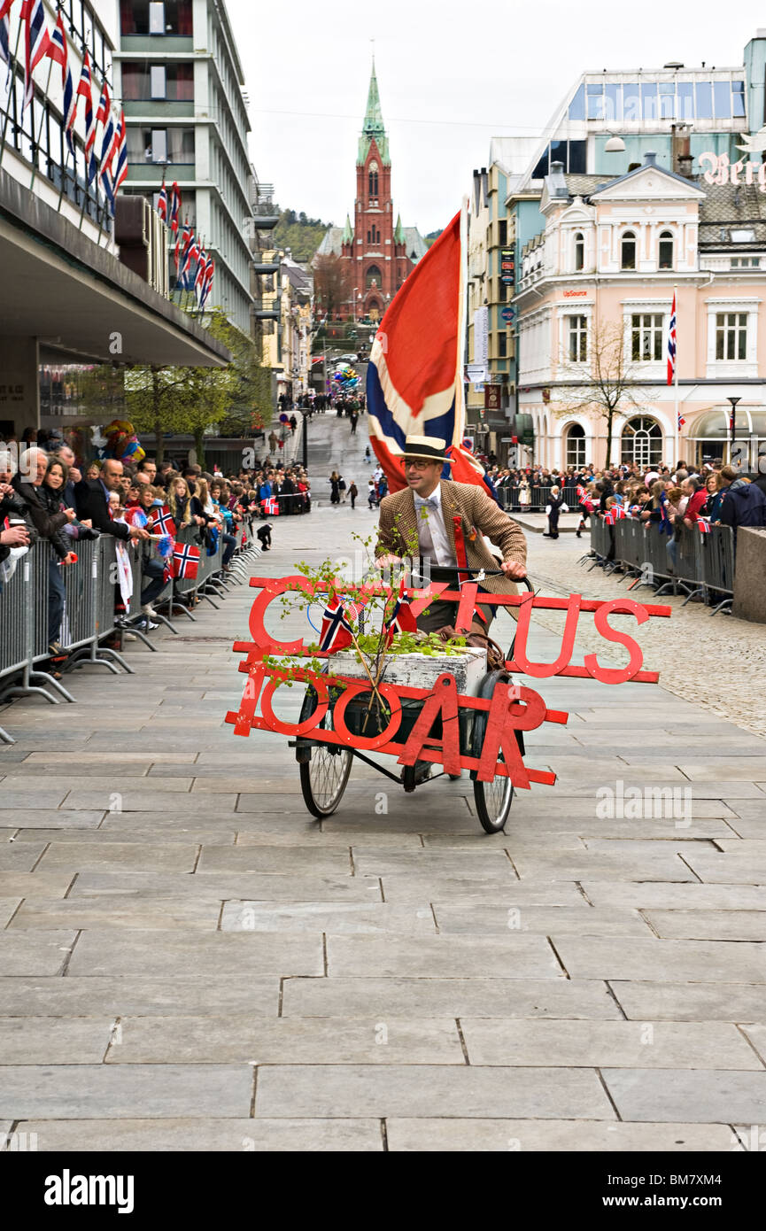 Man on a Tricycle Makes His Way to The Independence Day Parade Start Amongst the Crowd in Bergen Norway Stock Photo