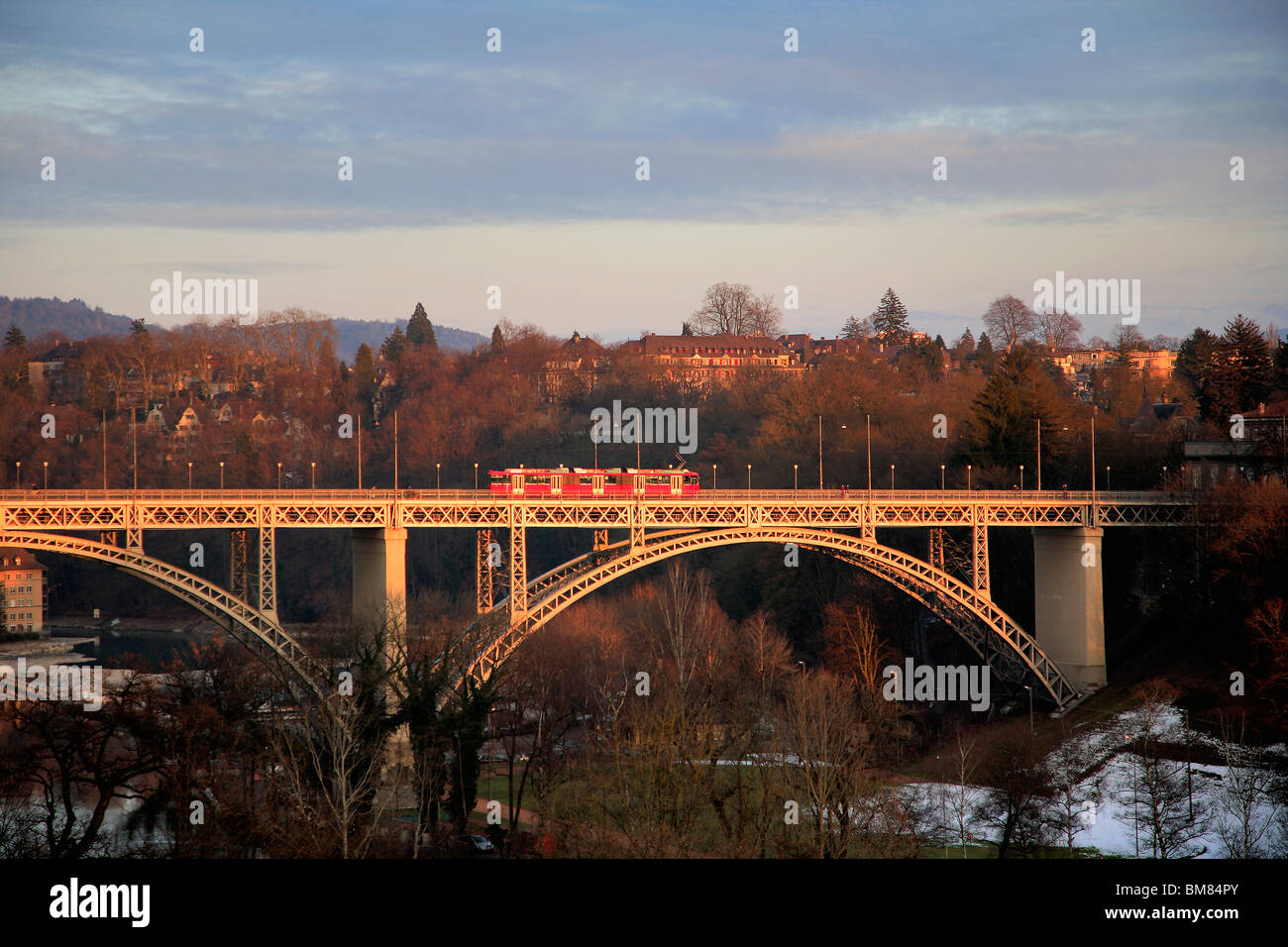 A tram passing over the river Aare bridge UNESCO world heritage site of Bern the capital city of Switzerland Oberland county Stock Photo