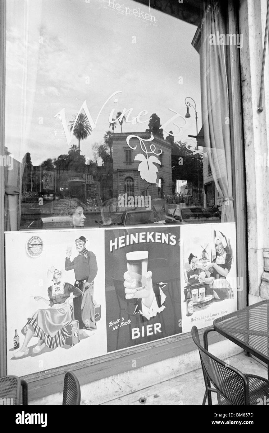 Rome, Italy, 30 January 2010 -- 'Wine Bar' advertises Heineken Beer, captured in black and white on Agfa APX 100 negative film. Stock Photo