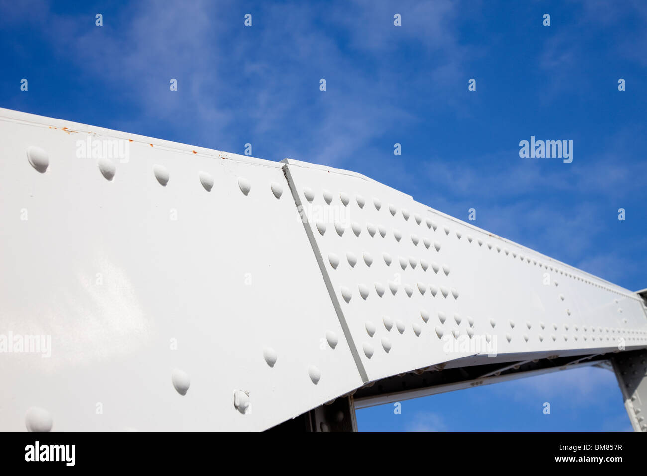 Riveted steel beam and joint at a steel bridge support structure Stock Photo