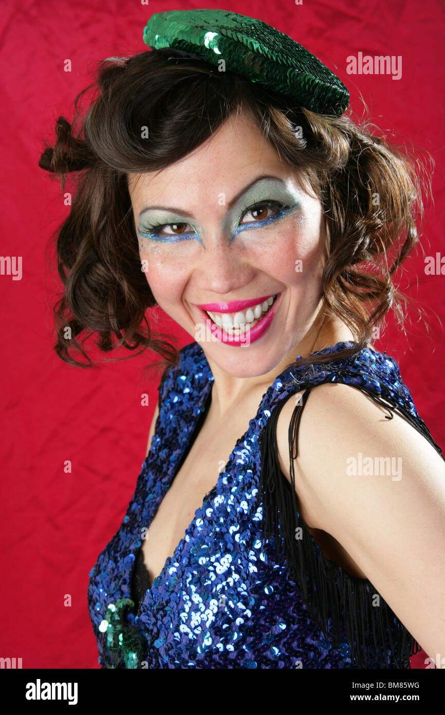 Young Woman Dressed in a Blue Sparkly Outfit and Green Hat in a Burlesque Style Stock Photo