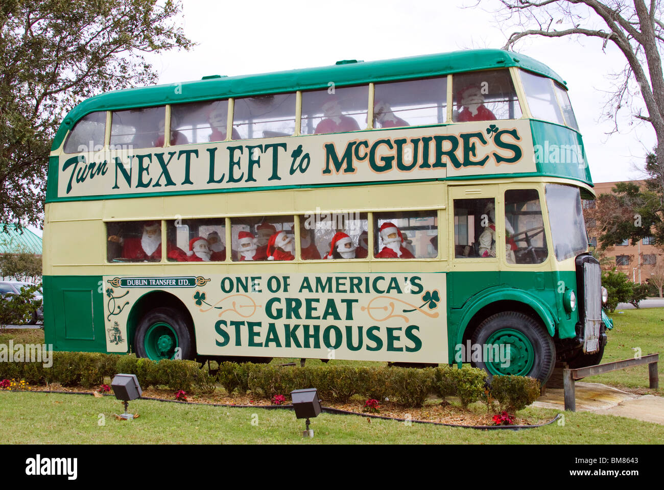 Santa Claus riding a double decker bus advertising a restaurant in Pensacola Florida Stock Photo