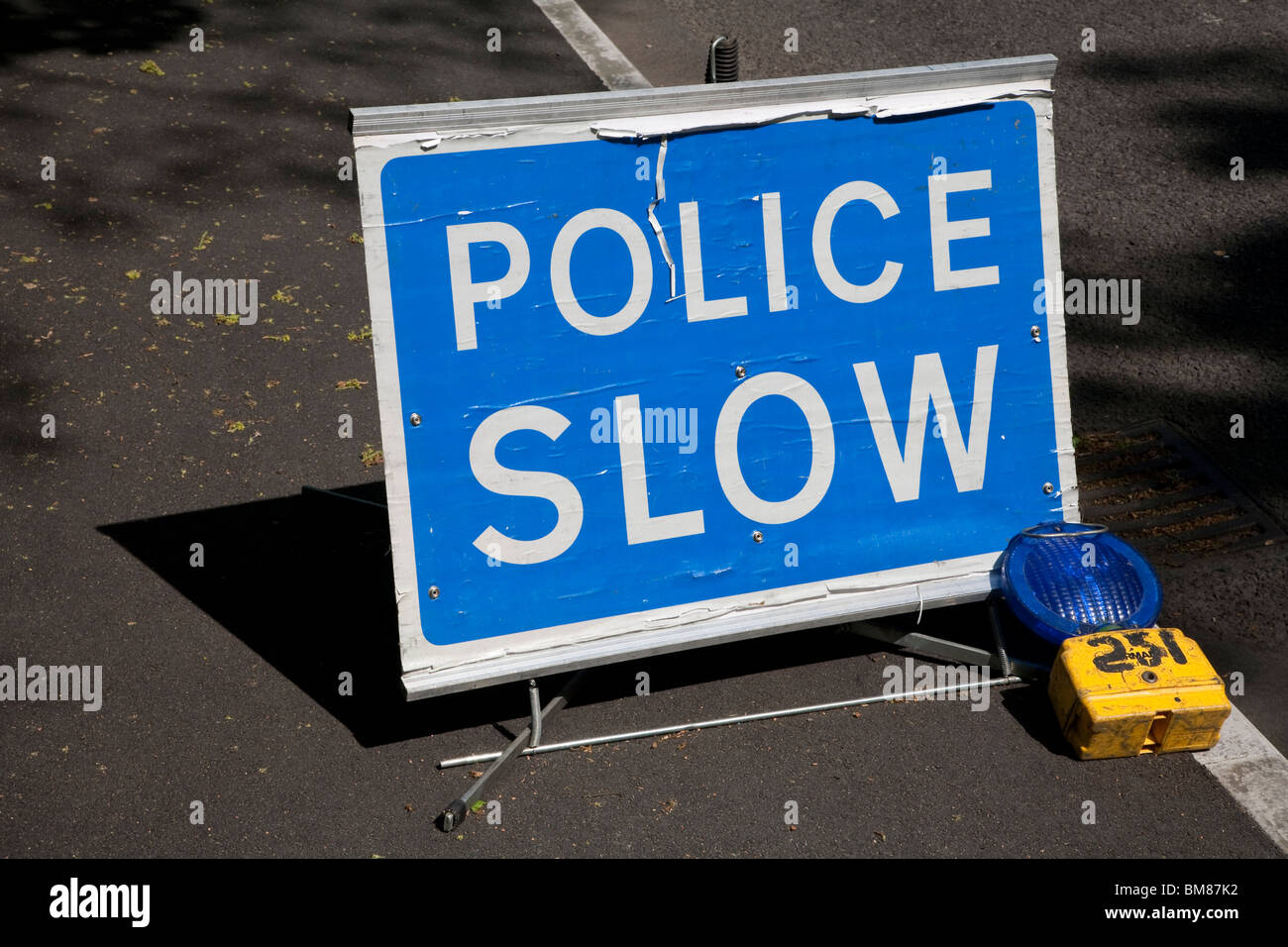 Police Slow sign with blue light Stock Photo