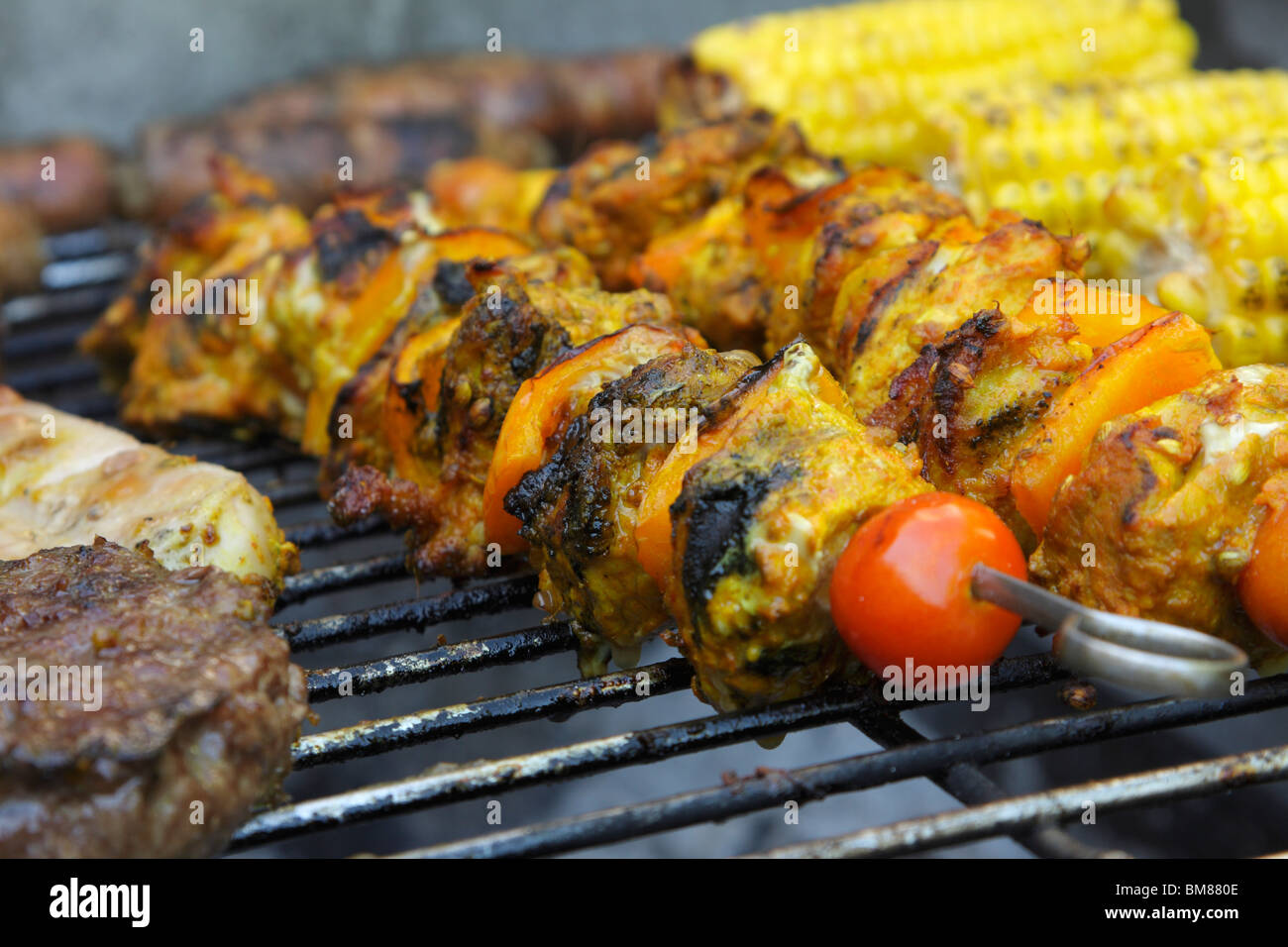 Pork kebabs cooking on a barbecue Stock Photo Alamy
