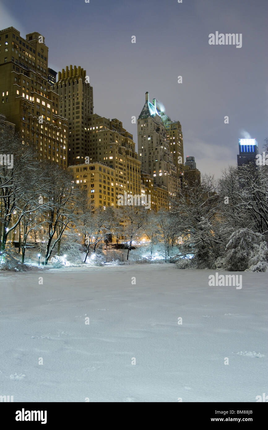The Pond at the south end of Central Park is frozen and covered with ...