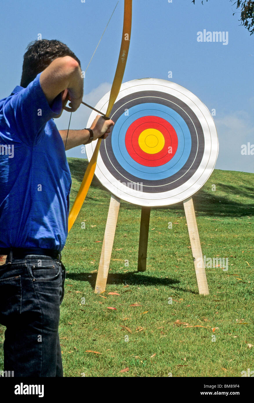 Archer teen boy male sport athlete bow arrow target aim shoot point tip