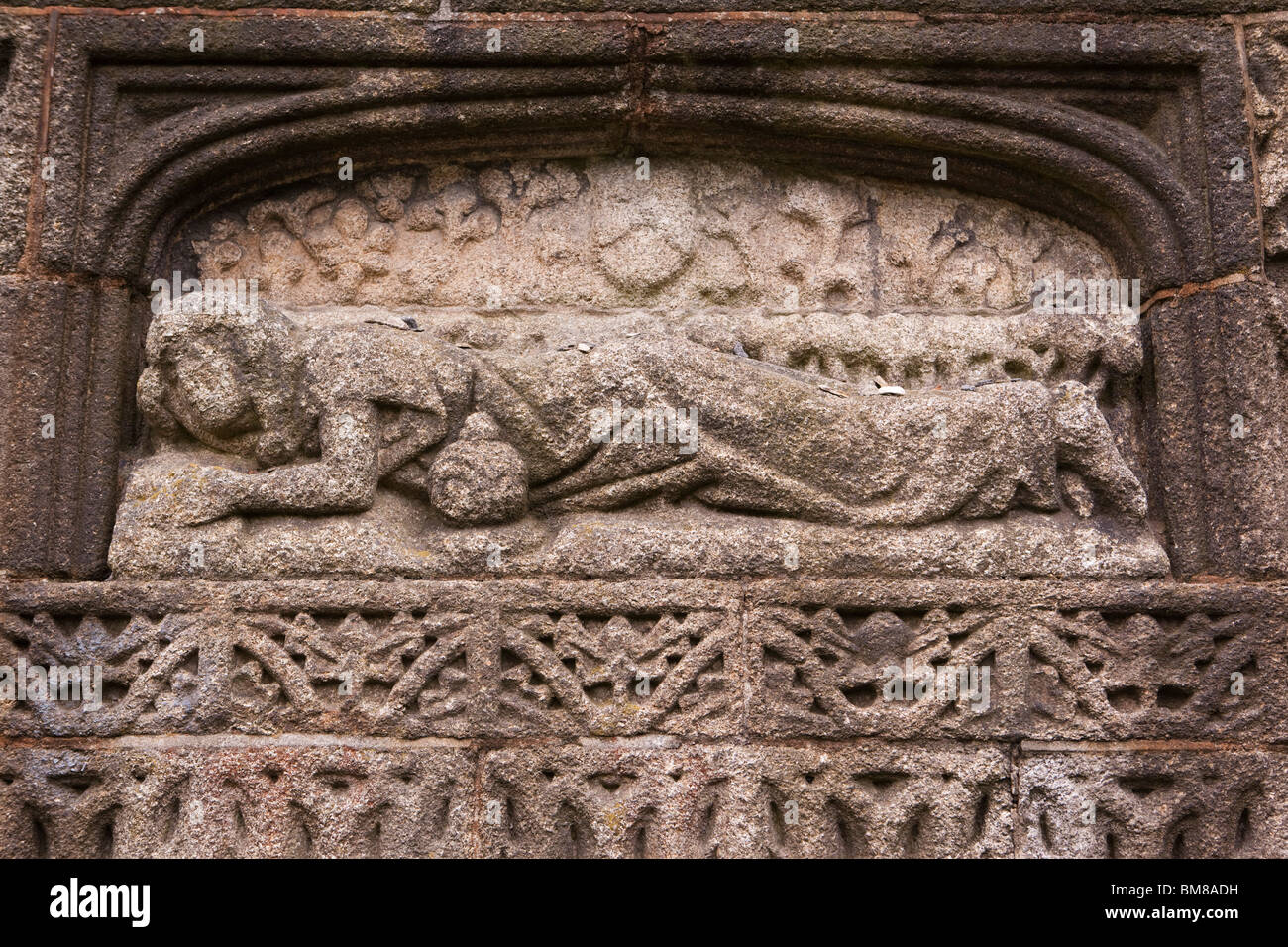 UK, England, Cornwall, Launceston, Church of St Mary Magdalene. figure on outside wall with pebbles thrown onto back Stock Photo