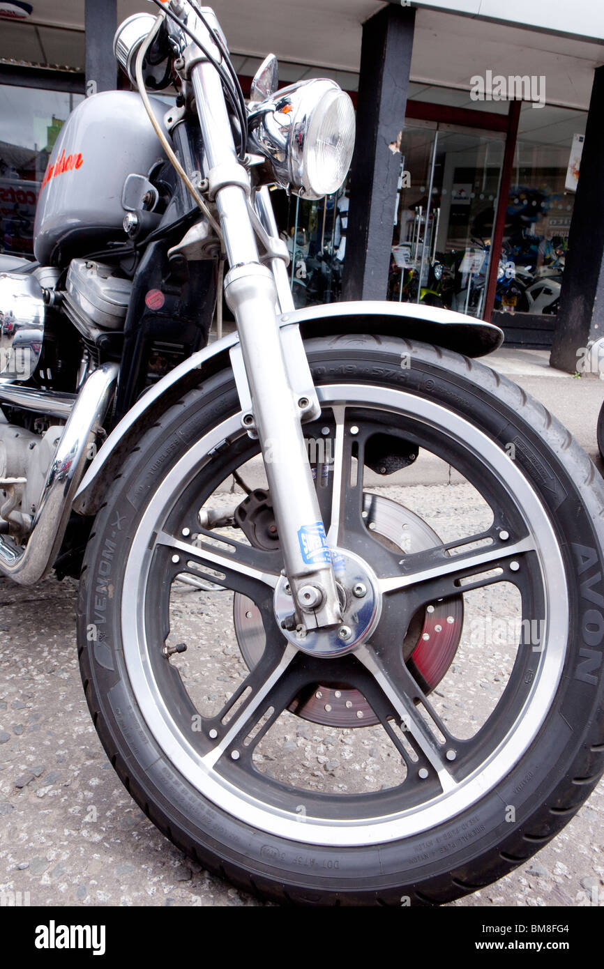 Motorcycle close up of front wheel and forks on a Harley Davidson