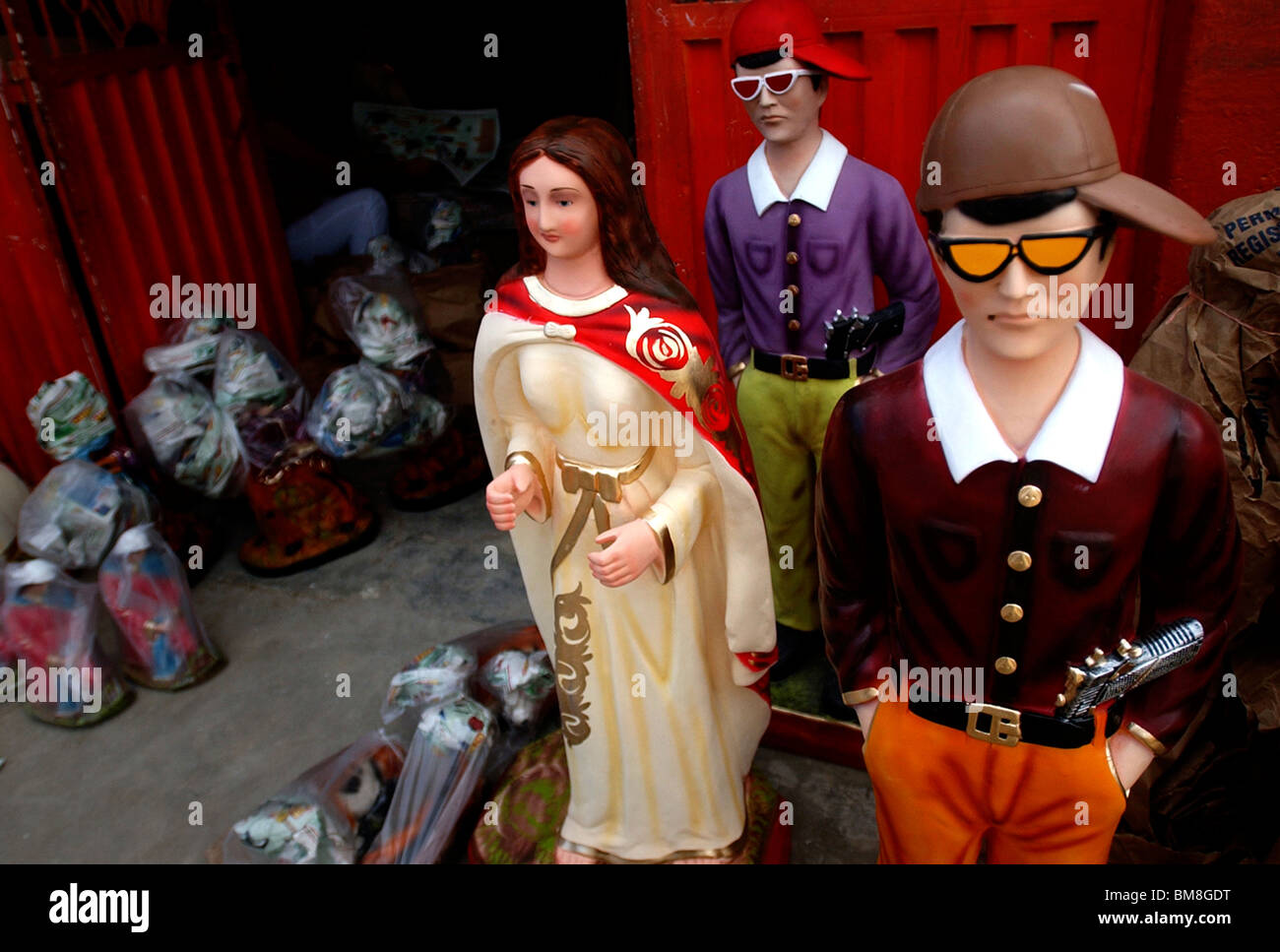 Statues of criminals wearing pistols at a ceramics workshop in San Cristobal, Venezuela. Stock Photo