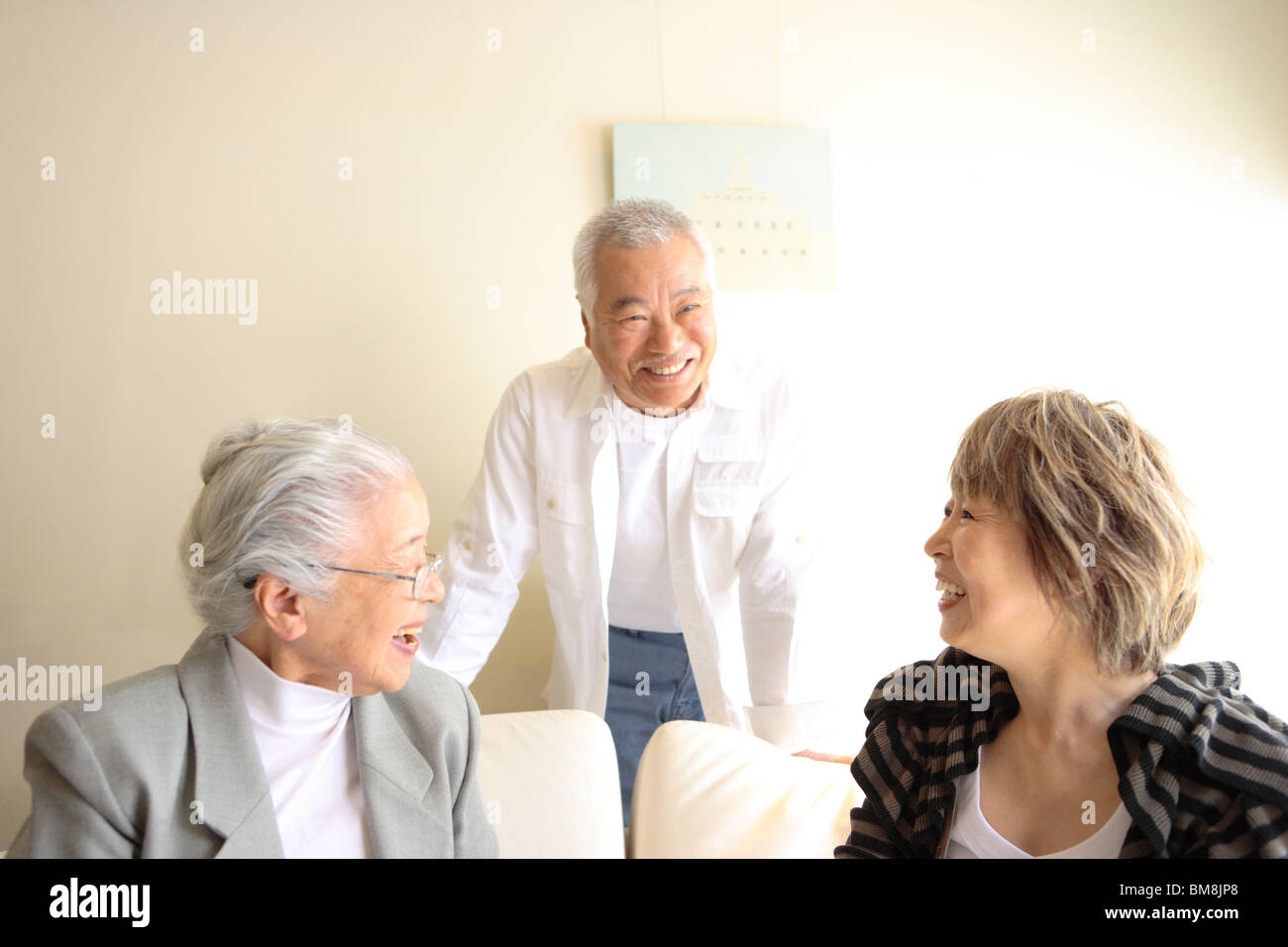 Two generation family in living room, smiling Stock Photo - Alamy