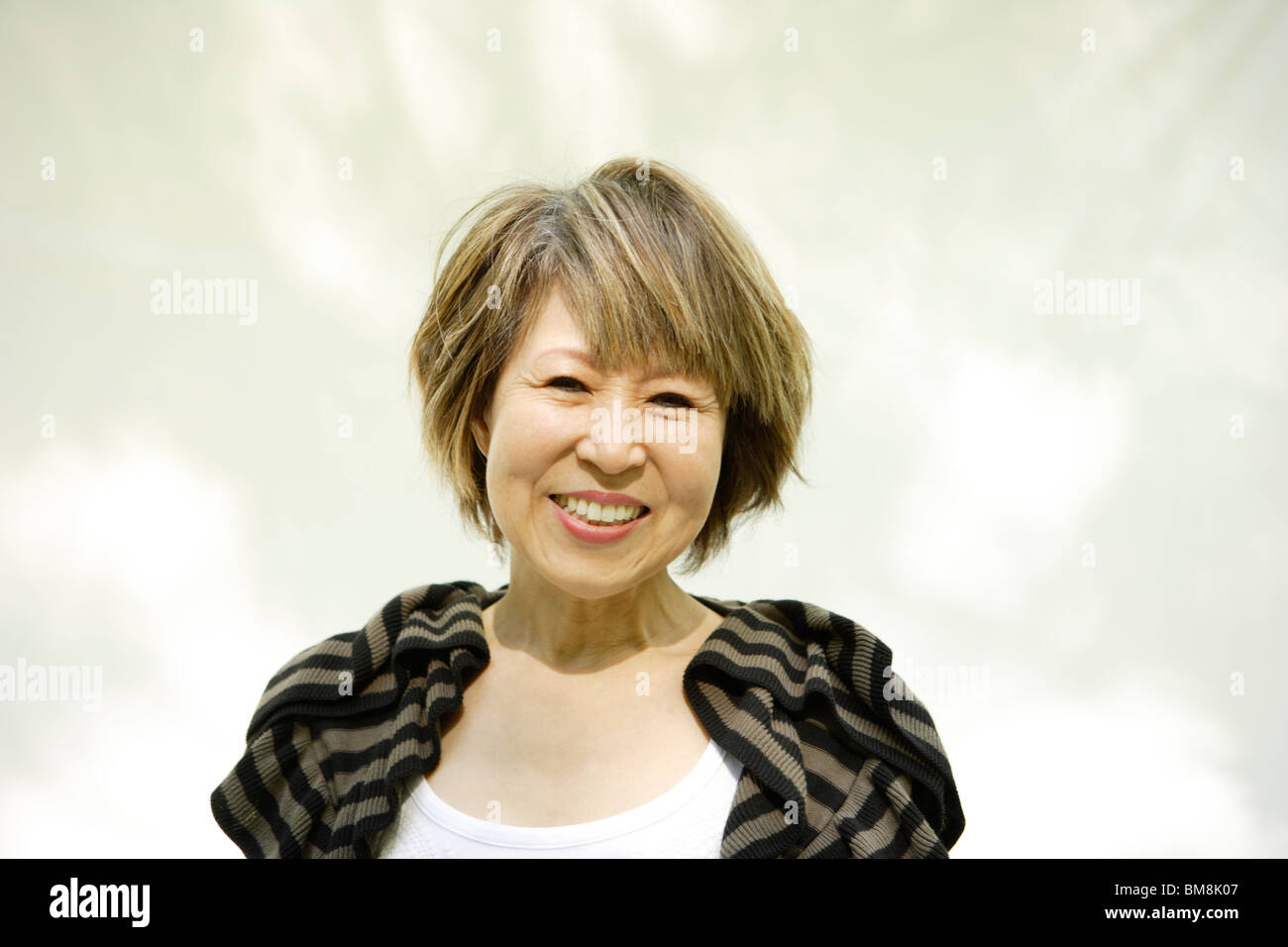Portrait of mature woman smiling, white background Stock Photo - Alamy