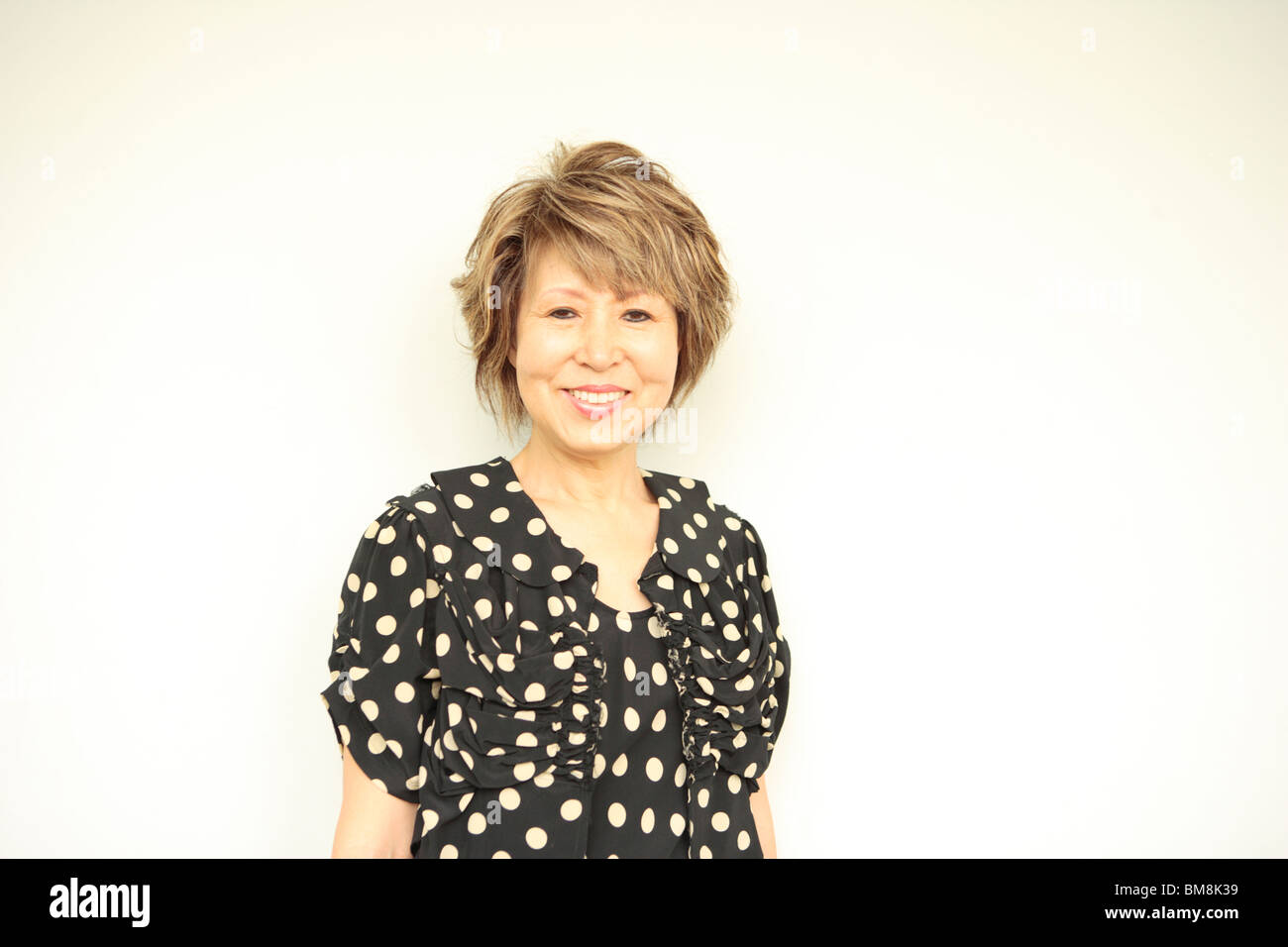 Portrait of mature woman smiling, white background Stock Photo - Alamy