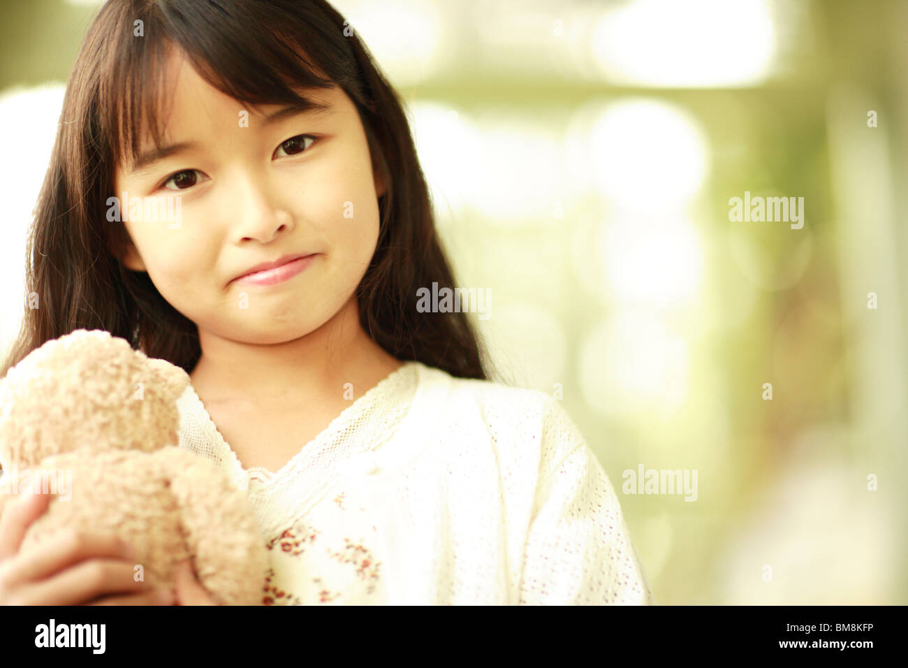 Portrait of a girl holding stuffed animal Stock Photo - Alamy