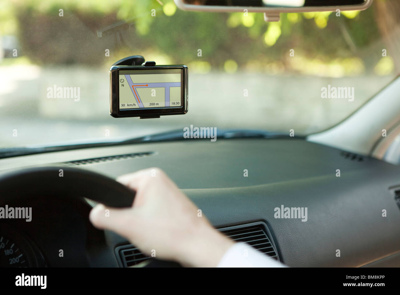 Driver using GPS unit for navigation assistance Stock Photo Alamy