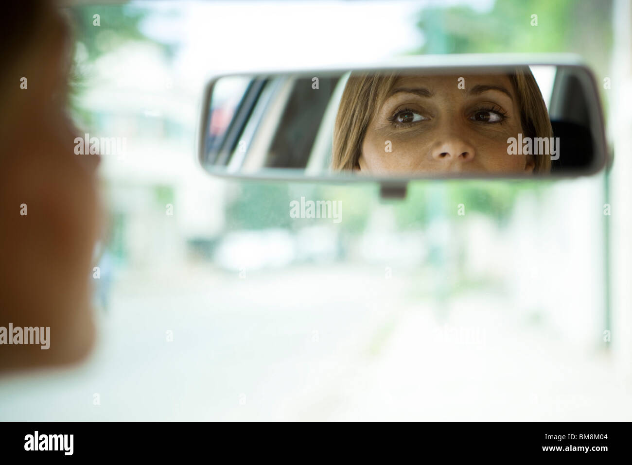 Driver checking rear view mirror Stock Photo