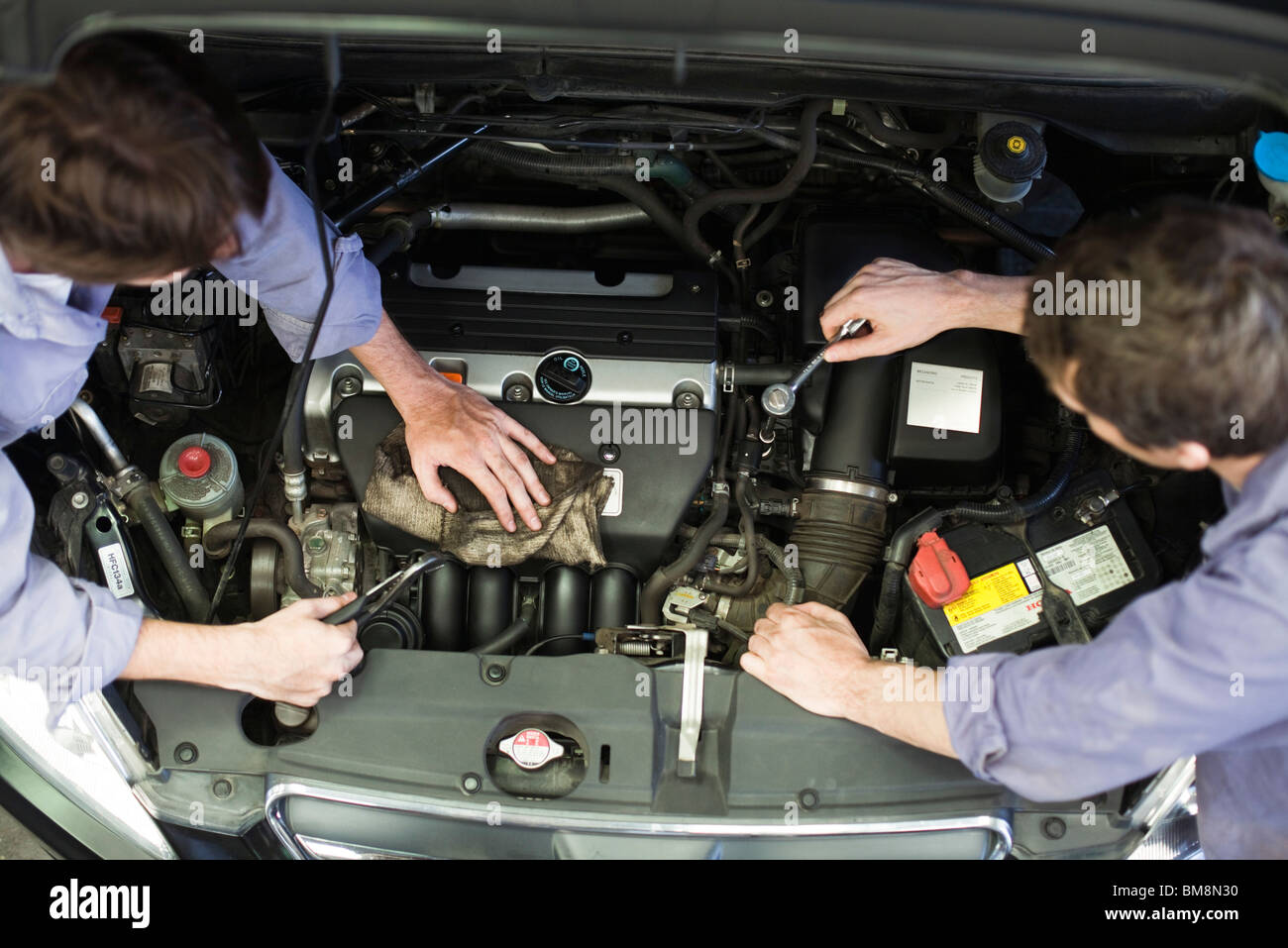 Mechanics reparing car engine Stock Photo - Alamy