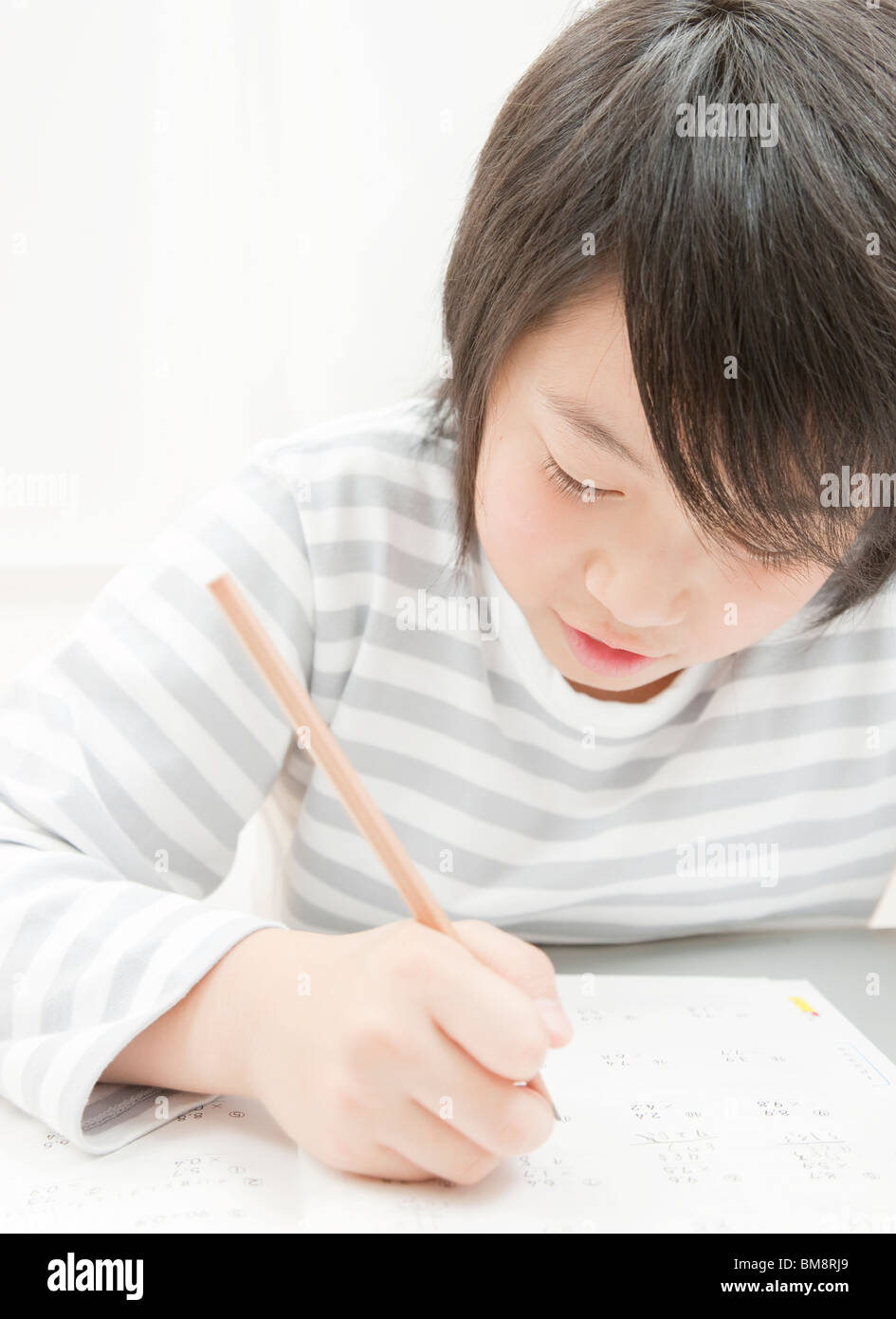 A Boy Studying at Desk Stock Photo