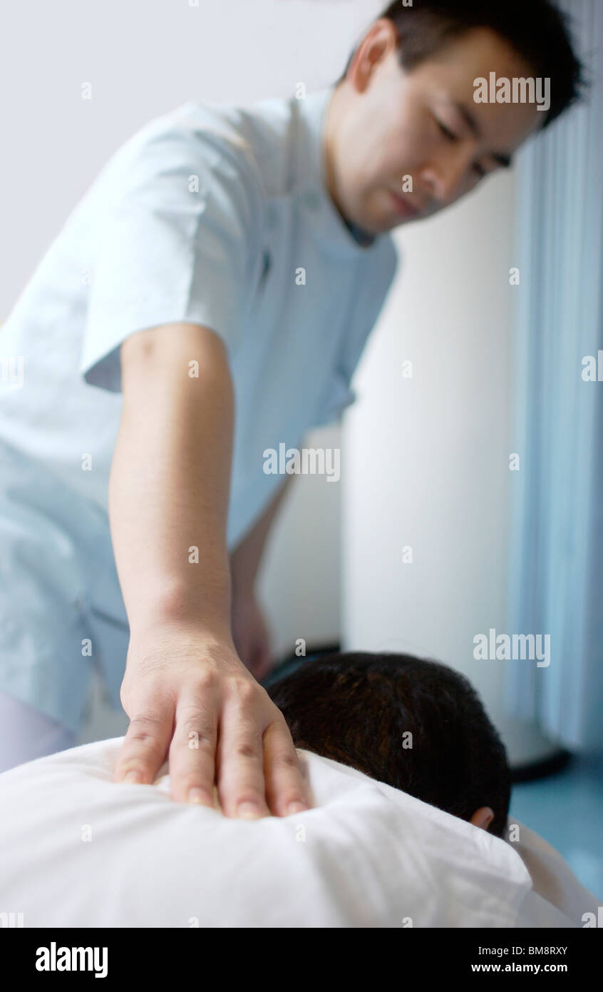 Massage therapist massaging man's back Stock Photo Alamy