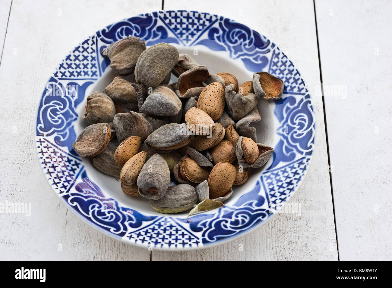 Fresh almonds in bowl Stock Photo