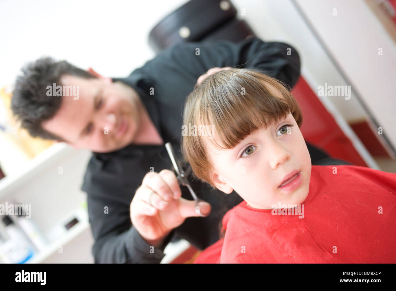 young boy having a haircut in barbers salon in north yorkshire Stock Photo