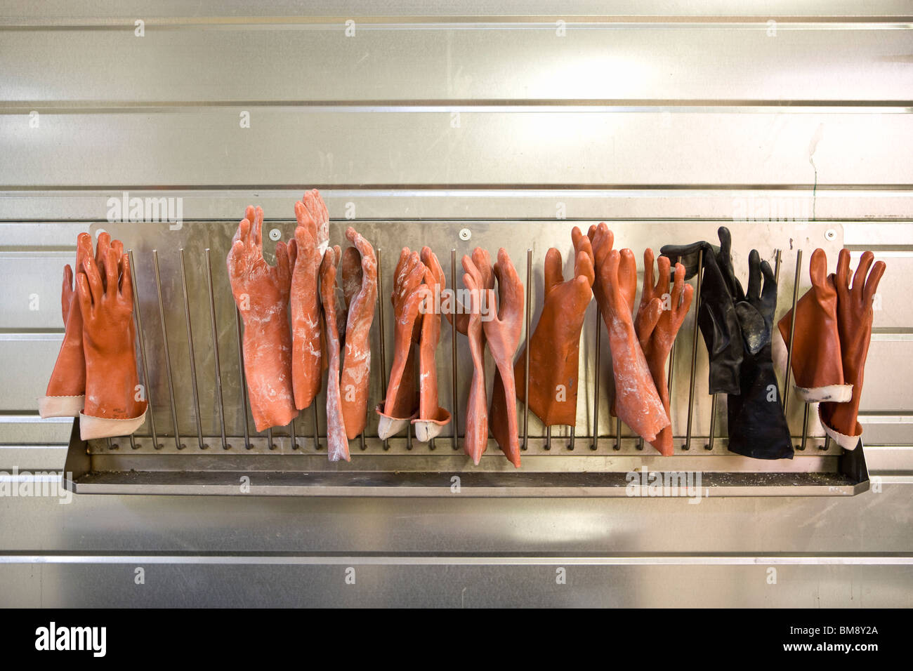 Fabric coating plant, rubber gloves drying on rack Stock Photo Alamy