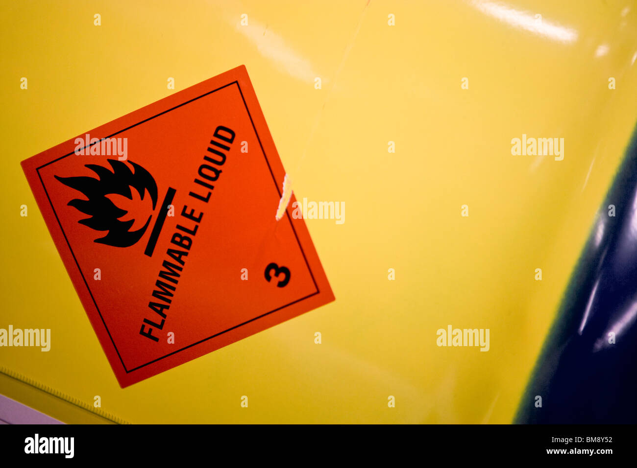 Fabric coating plant, flammable warning label on side of metal drum Stock Photo