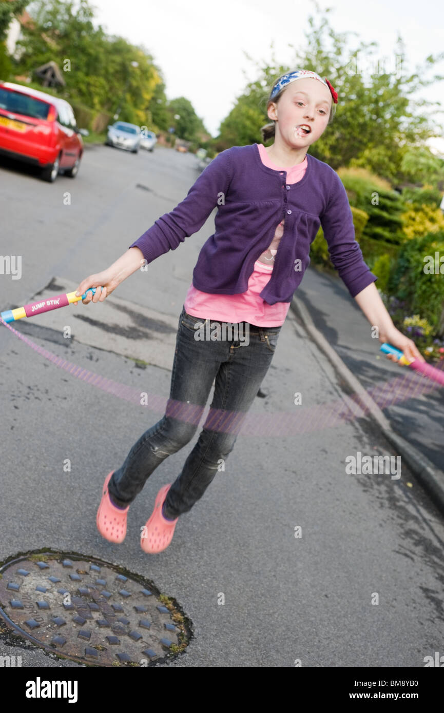 Girl skipping in the road in North Yorkshire Stock Photo Alamy