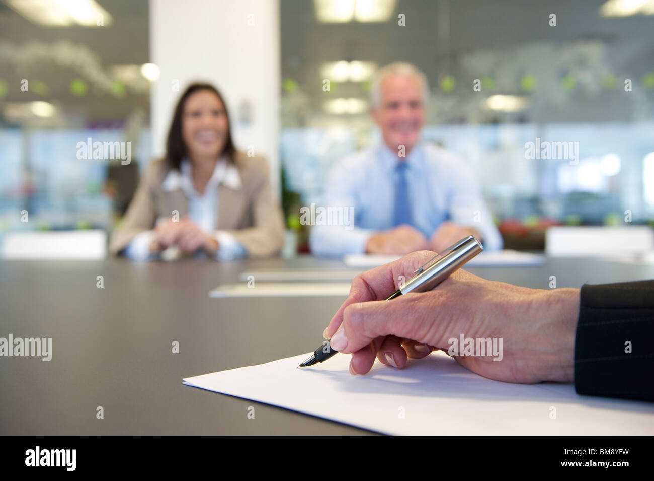 Abstract hand and pen in a business meeting Stock Photo