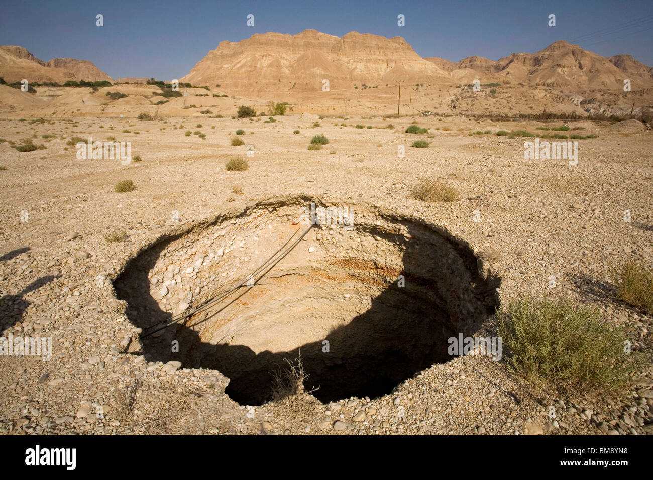 Israel, Dead Sea A sinkhole caused by the receding water level of the Dead Sea Stock Photo